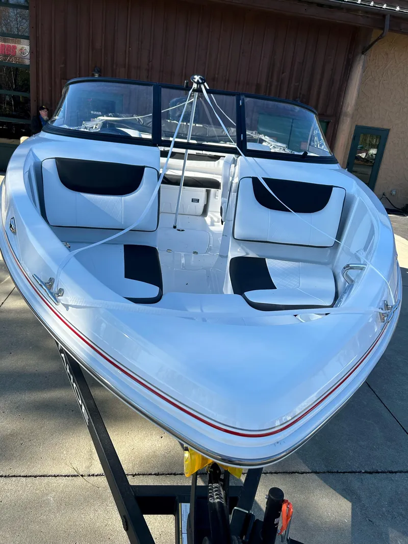 Slide: The Image of 2024 Tahoe 200 S boat with white and black interior on a trailer. - 6