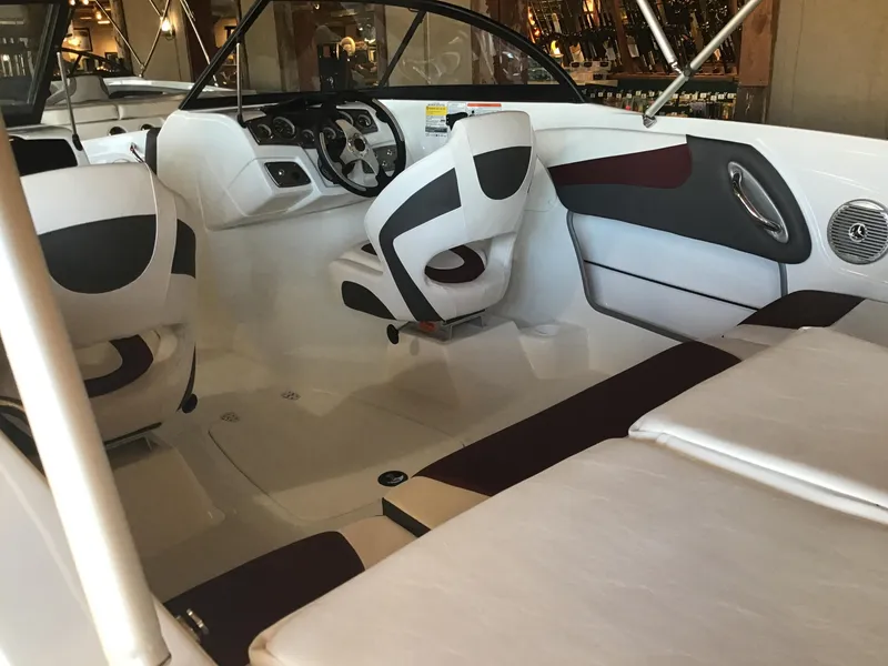 Slide: The Image of 2024 Tahoe 200 S boat interior with white and black seating, steering wheel, and dashboard. - 38