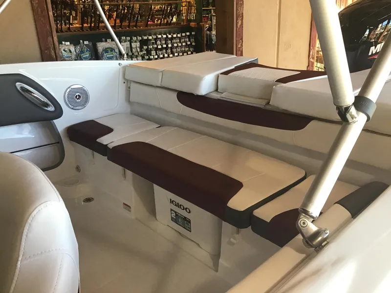 Slide: The Image of 2024 Tahoe 200 S boat interior with cushioned seating and Igloo cooler. - 39