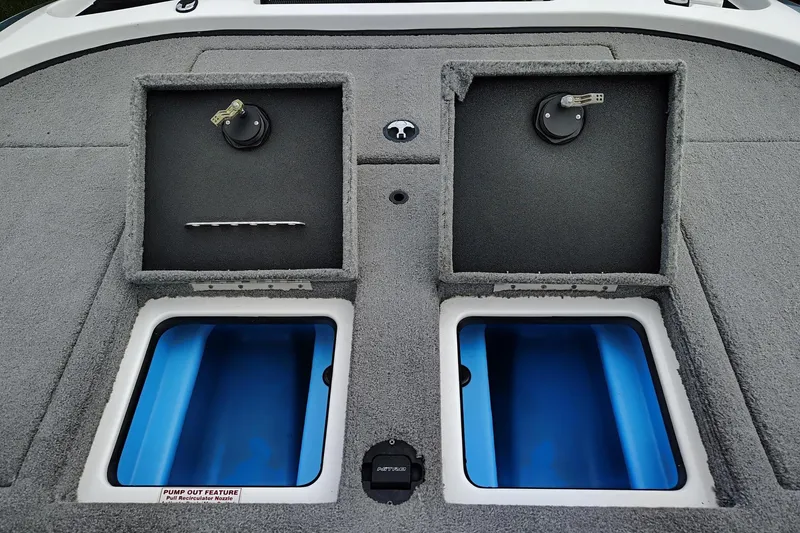 Slide: The Image of 2024 Nitro Z20 boat storage compartments with blue interiors and pump-out feature. - 5