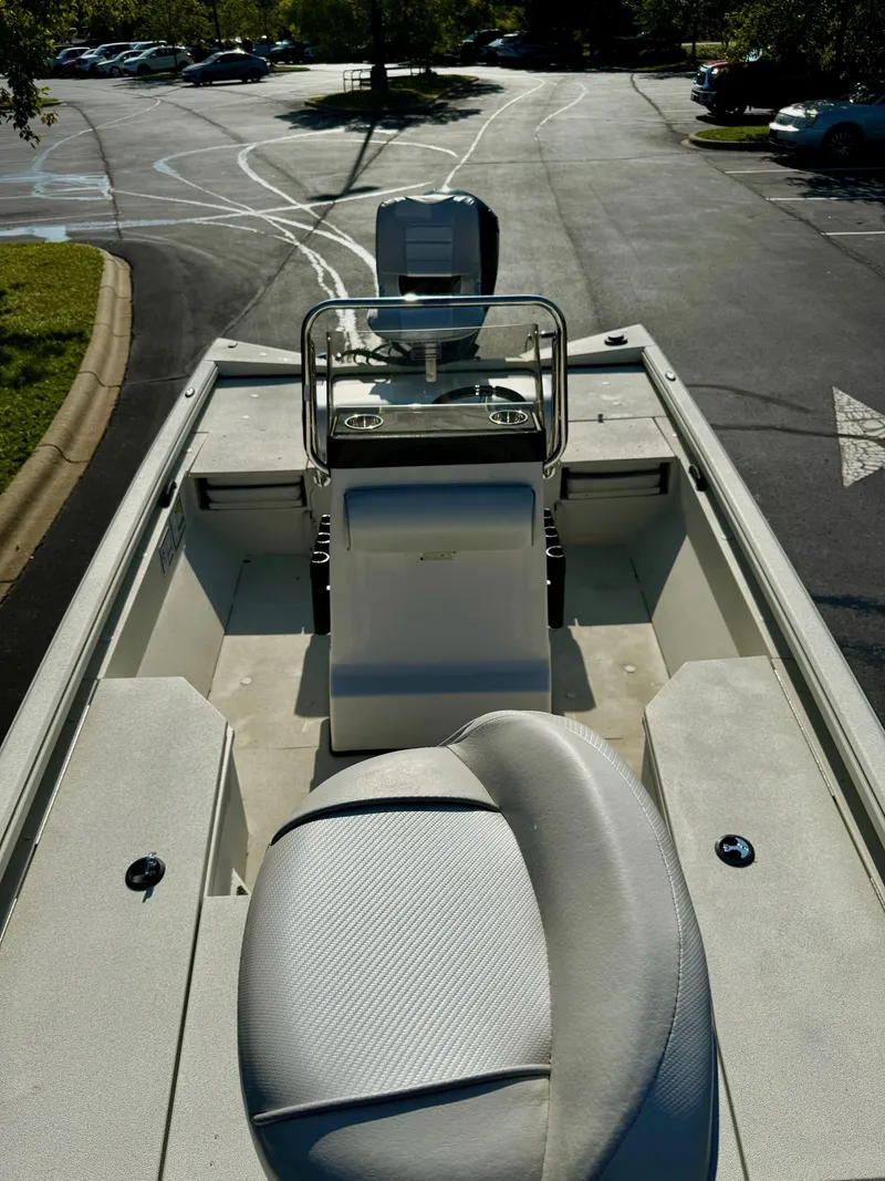 Slide: The Image of 2024 Ranger RB190 boat interior with seating and console, parked outdoors. - 4
