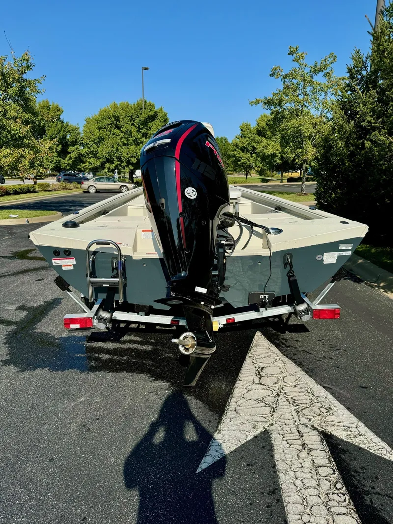Slide: The Image of 2024 Ranger RB190 boat with outboard motor on a trailer in a parking lot. - 5