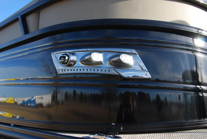 Slide: The Image of Close-up of 2024 Regency 230 LE3 boat's sleek black exterior and LED lights. - 10