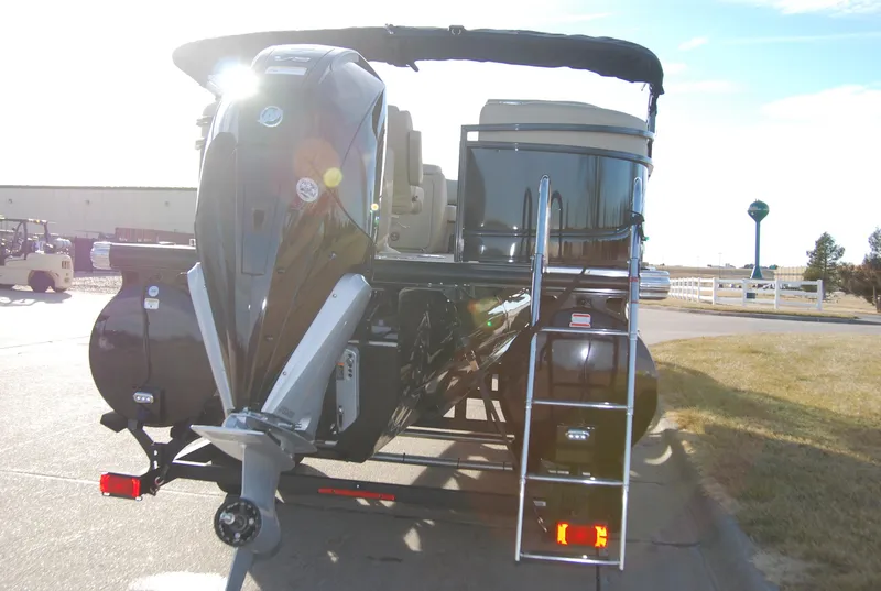 Slide: The Image of 2024 Regency 230 LE3 pontoon boat with outboard motor and ladder. - 3