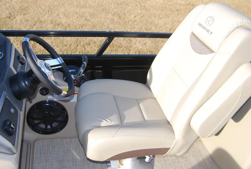 Slide: The Image of 2024 Regency 230 LE3 boat captain's chair and steering console. - 5