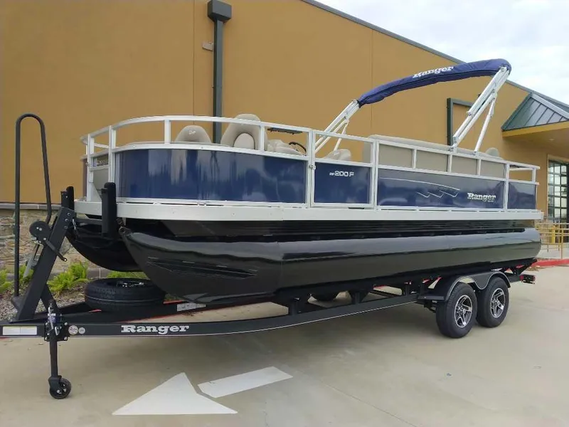 Slide: The Image of 2024 Ranger Reata 200F pontoon boat on a trailer. - 0