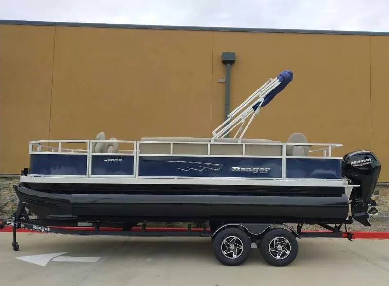 Slide: The Image of 2024 Ranger Reata 200F pontoon boat on trailer, side view. - 1