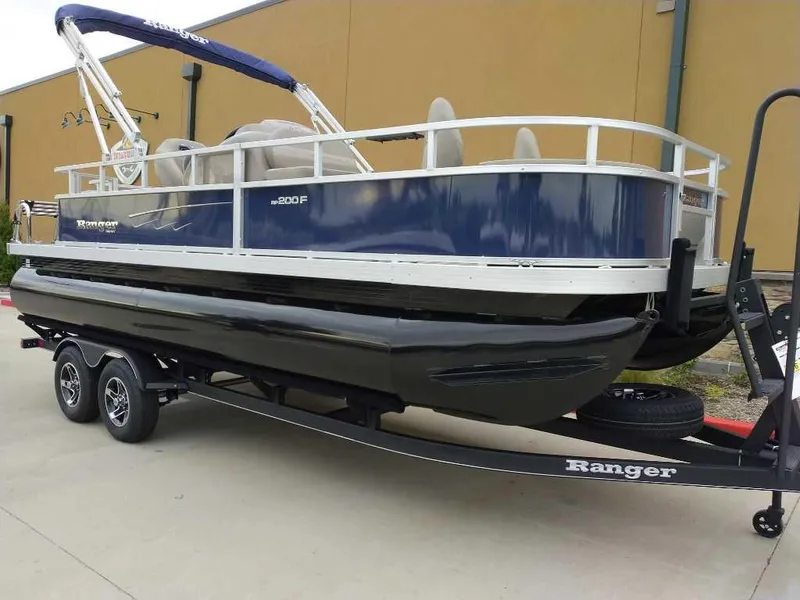 Slide: The Image of 2024 Ranger Reata 200F pontoon boat on trailer, side view. - 5