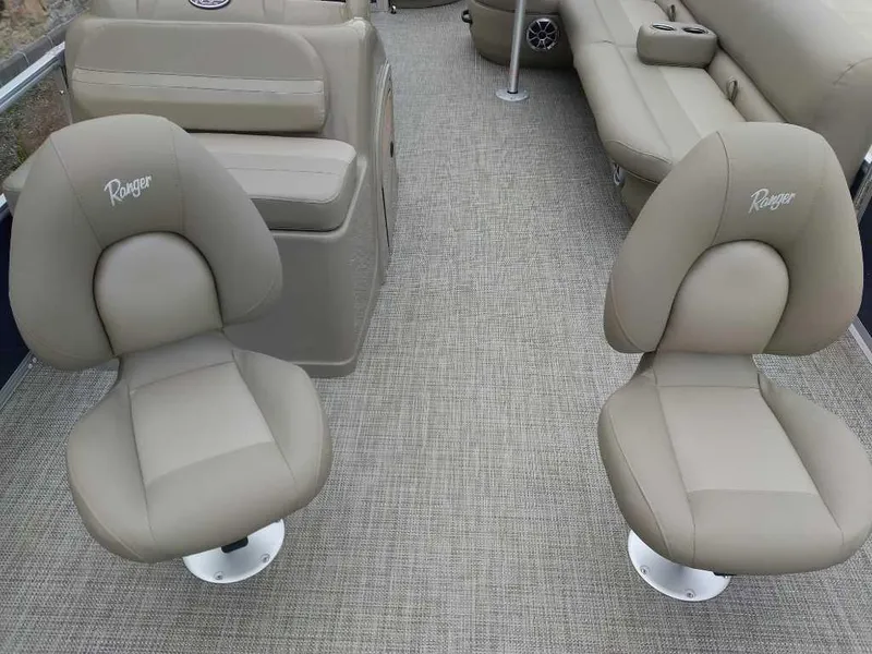 Slide: The Image of 2024 Ranger Reata 200F boat interior with beige seating and carpet. - 8
