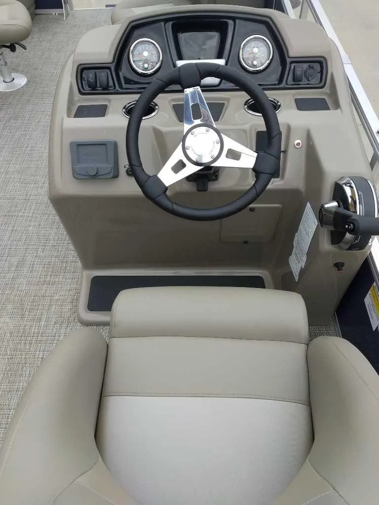 Slide: The Image of 2024 Ranger Reata 200F boat console with steering wheel and controls. - 9
