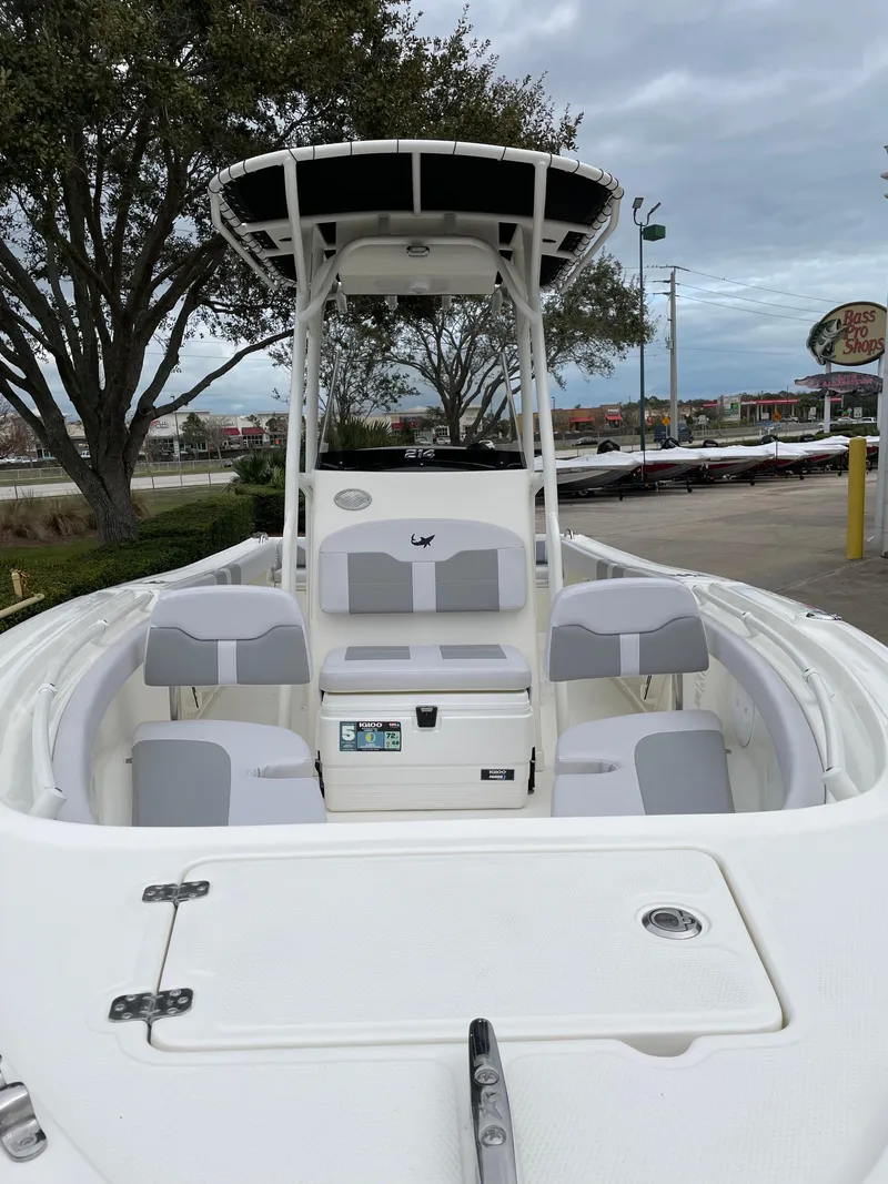 Slide: The Image of 2024 Mako 214 CC boat with seating, docked outdoors. - 5