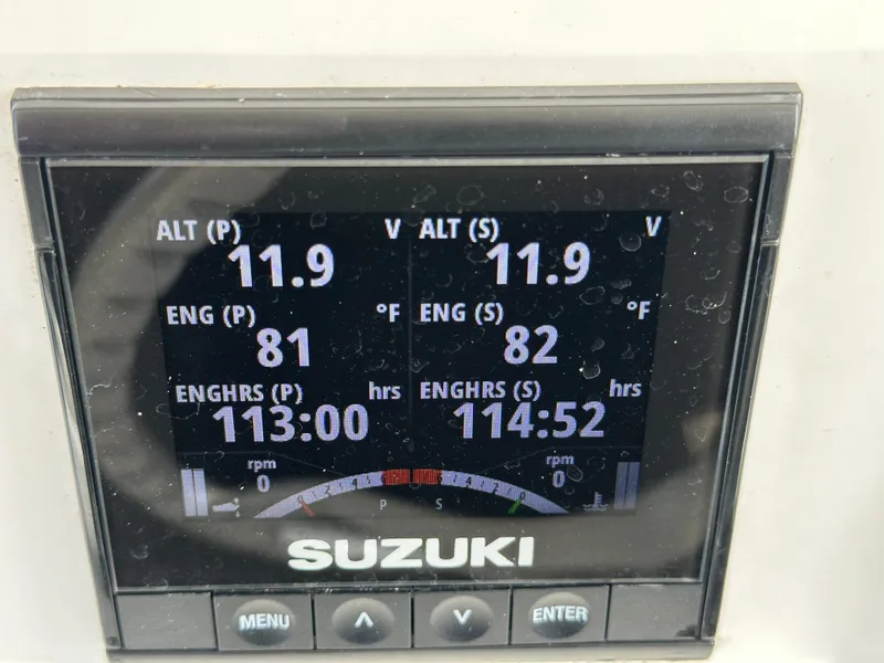 Slide: The Image of Suzuki engine display on a 2002 Jupiter 27 Open Fisherman boat showing engine hours and temperatures. - 11