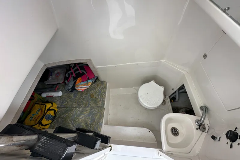 Slide: The Image of 2002 Jupiter 27 Open Fisherman boat interior with toilet and sink. - 17
