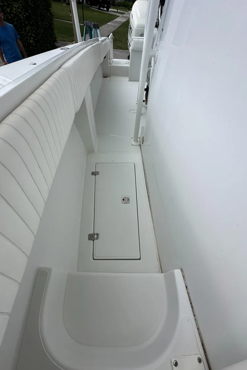 Slide: The Image of 2002 Jupiter 27 Open Fisherman boat interior with white seating and storage compartment. - 20