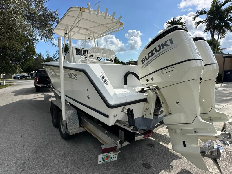 Slide: The Image of 2002 Jupiter 27 Open Fisherman boat with twin Suzuki outboard engines on a trailer. - 3