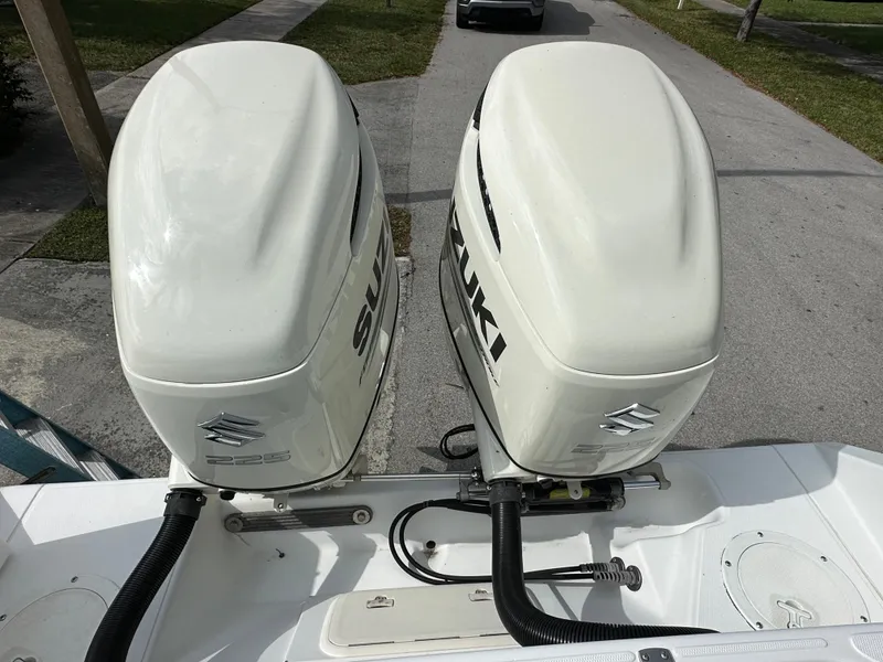 Slide: The Image of Twin Suzuki outboard motors on a 2002 Jupiter 27 Open Fisherman boat. - 5
