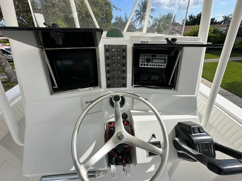 Slide: The Image of Control console of a 2002 Jupiter 27 Open Fisherman boat with steering wheel and electronics. - 7