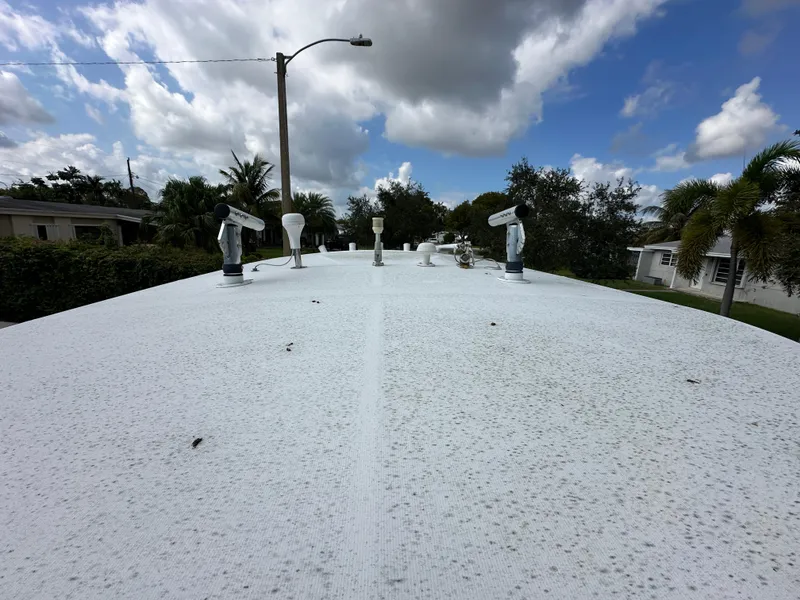 Slide: The Image of Top view of a 2002 Jupiter 27 Open Fisherman boat under a cloudy sky. - 9
