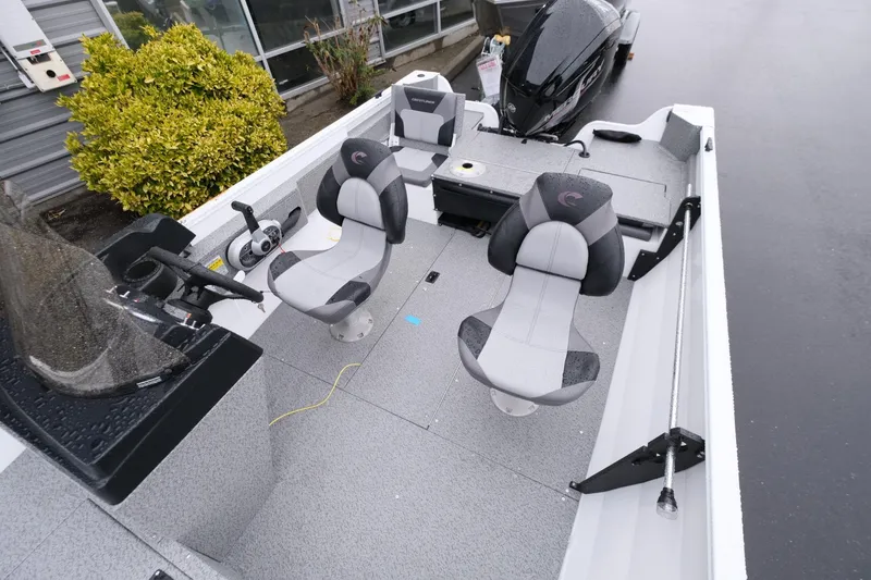 Slide: The Image of 2024 Crestliner 1600 Vision boat interior with seating and controls. - 10