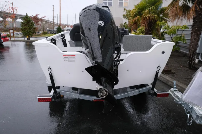 Slide: The Image of 2024 Crestliner 1600 Vision boat on trailer, rear view, parked outdoors. - 4