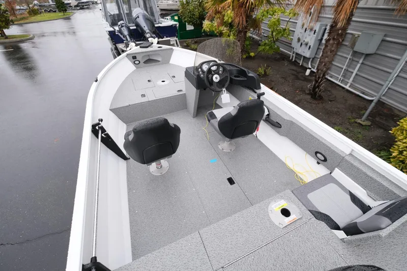 Slide: The Image of 2024 Crestliner 1600 Vision boat interior with seating and steering console. - 6