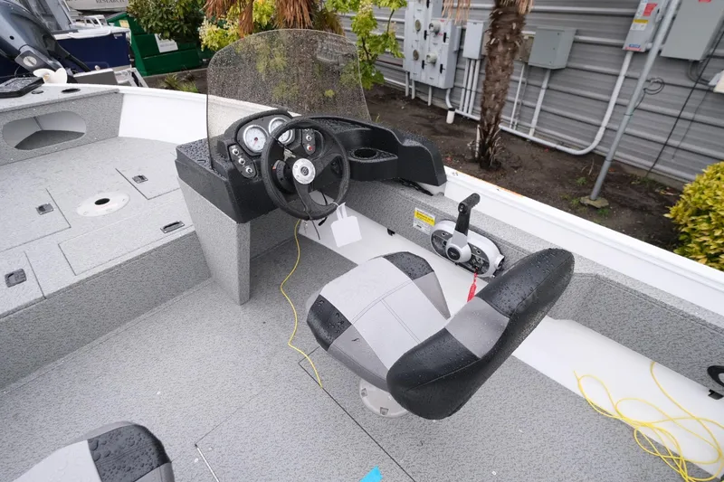 Slide: The Image of 2024 Crestliner 1600 Vision boat interior with steering console and seating. - 7