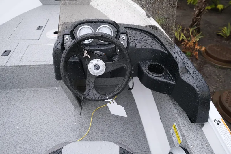 Slide: The Image of 2024 Crestliner 1600 Vision boat dashboard with steering wheel and gauges. - 8