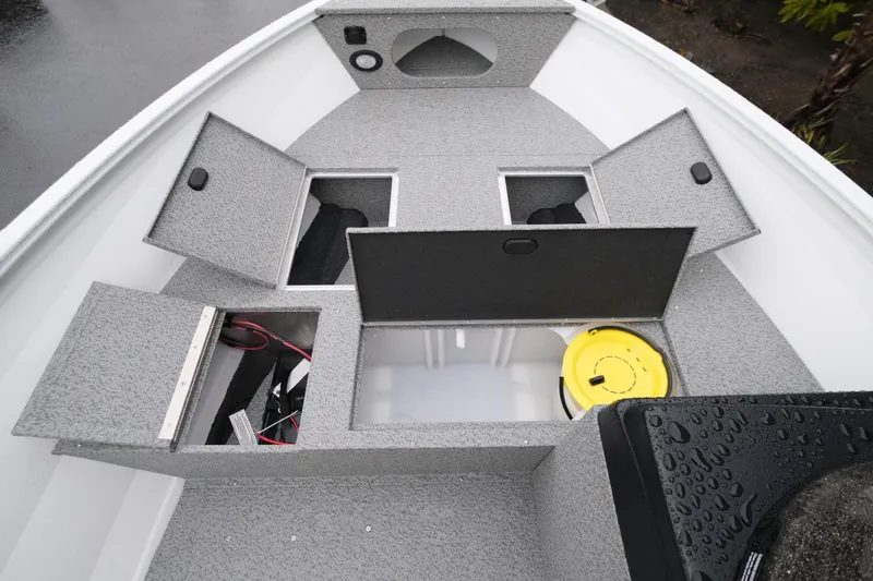 Slide: The Image of 2024 Crestliner 1600 Vision boat with open storage compartments and a yellow bucket. - 9