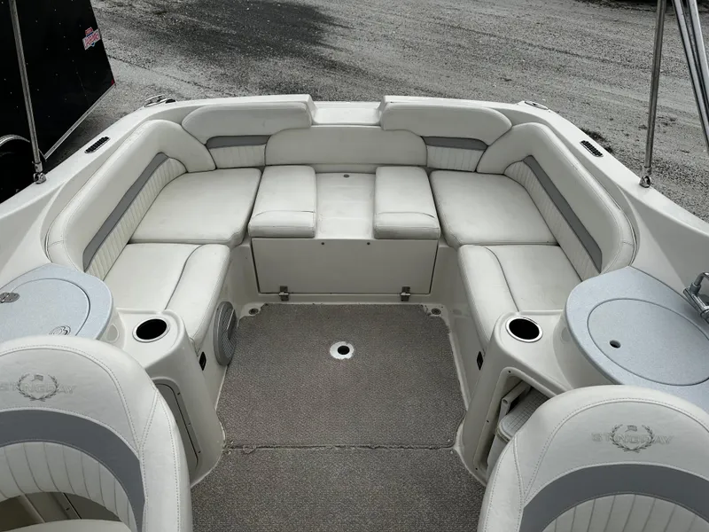 Slide: The Image of 2011 Stingray 250 LR boat interior with white cushioned seating. - 13