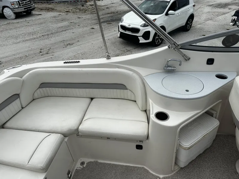 Slide: The Image of 2011 Stingray 250 LR boat interior with white seating and sink area. - 16