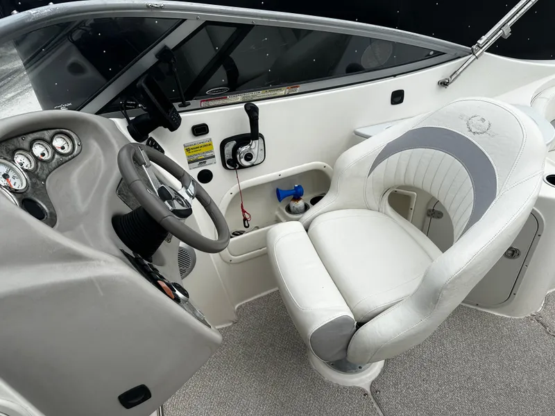 Slide: The Image of 2011 Stingray 250 LR boat cockpit with steering wheel and captain's chair. - 20