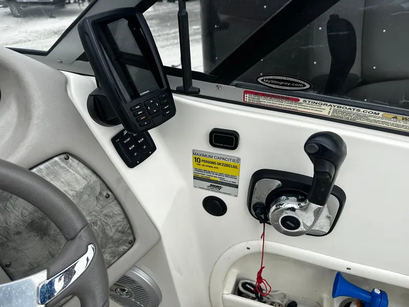 Slide: The Image of 2011 Stingray 250 LR boat dashboard with control panel and navigation system. - 22