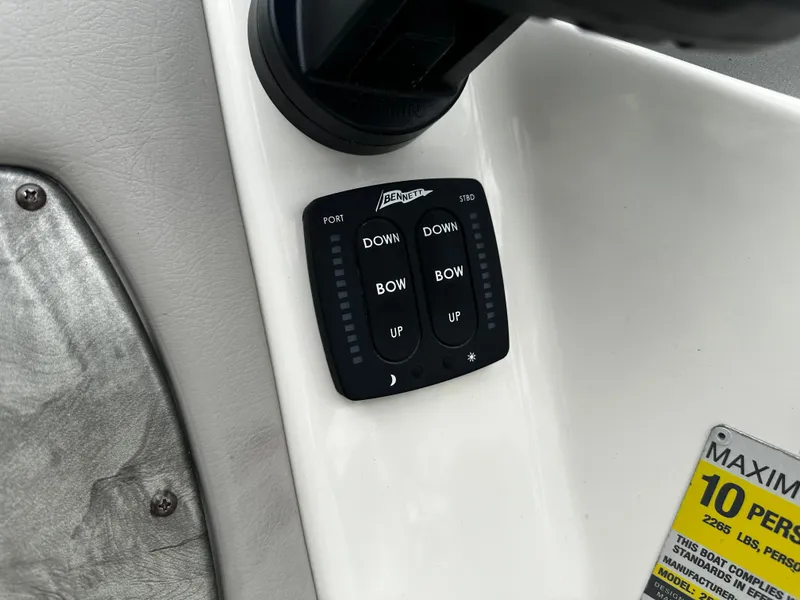 Slide: The Image of Control panel of a 2011 Stingray 250 LR boat with trim tab buttons. - 27
