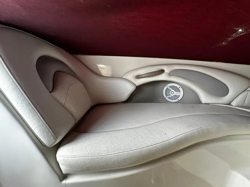 Slide: The Image of 2011 Stingray 250 LR boat interior with white leather seating and built-in speaker. - 33