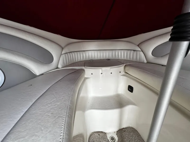 Slide: The Image of Interior of a 2011 Stingray 250 LR boat with white leather seating. - 35