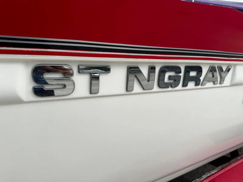 Slide: The Image of Stingray 250 LR 2011 boat logo on red and white hull - 6