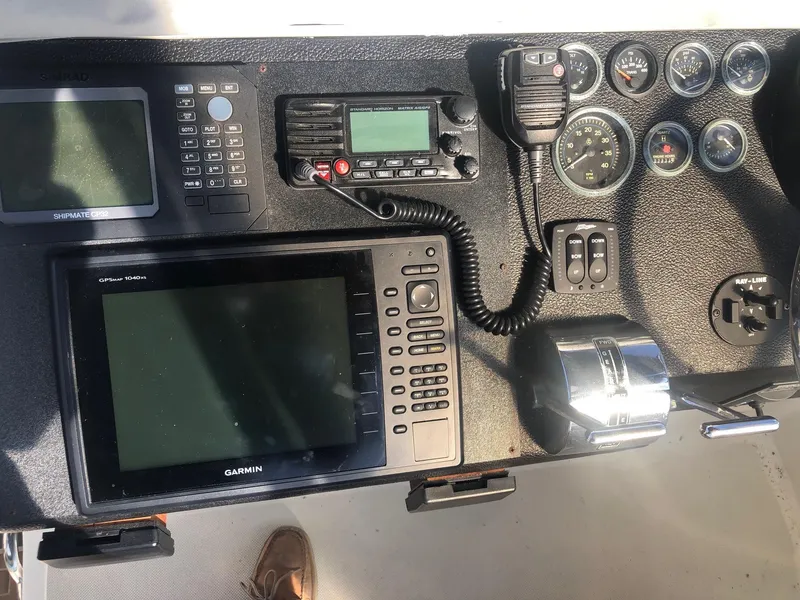 Slide: The Image of Control panel of a 1990 Mediterranean 38 Sport Fisher with navigation and communication equipment. - 22