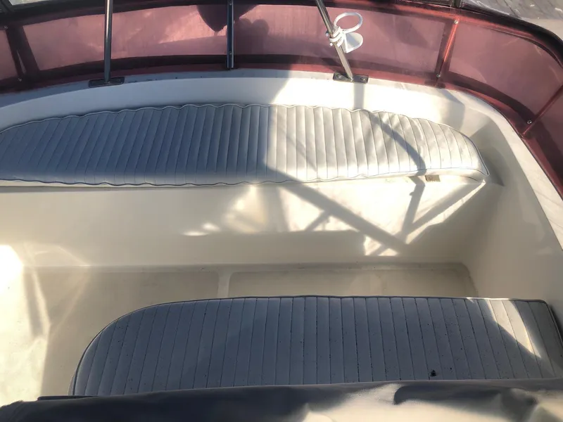 Slide: The Image of 1990 Mediterranean 38 Sport Fisher boat interior with cushioned seating and red canopy. - 23