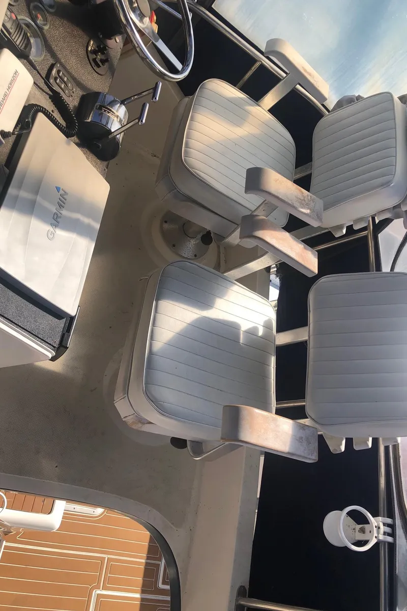 Slide: The Image of 1990 Mediterranean 38 Sport Fisher boat interior with two white captain chairs. - 24