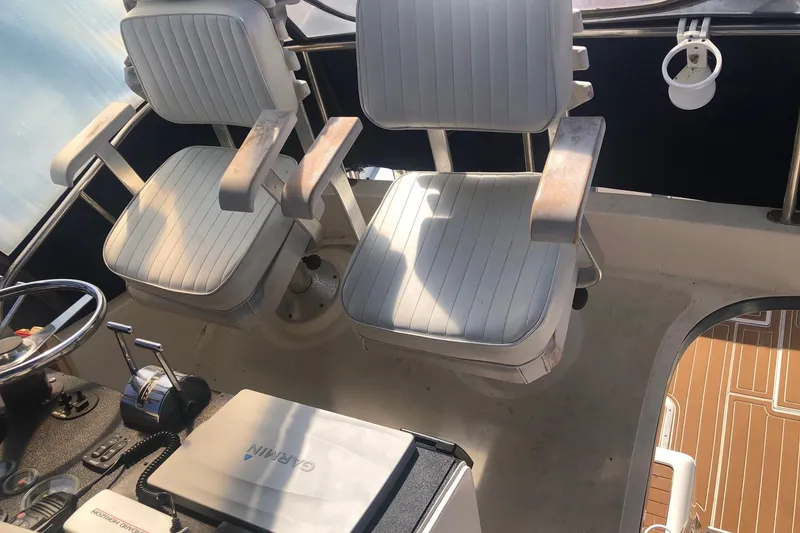 Slide: The Image of Cockpit of 1990 Mediterranean 38 Sport Fisher with dual captain chairs and control panel. - 27