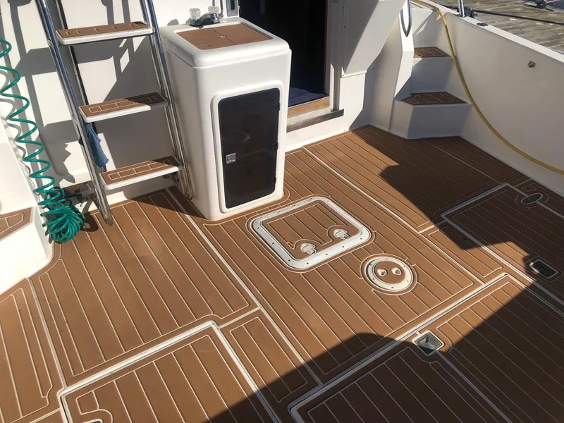 Slide: The Image of 1990 Mediterranean 38 Sport Fisher boat deck with wood finish and storage compartments. - 3