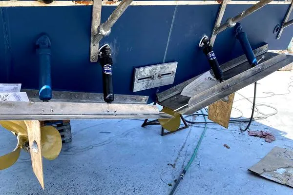 Slide: The Image of Rear view of a 1990 Mediterranean 38 Sport Fisher boat with visible propellers and trim tabs. - 32