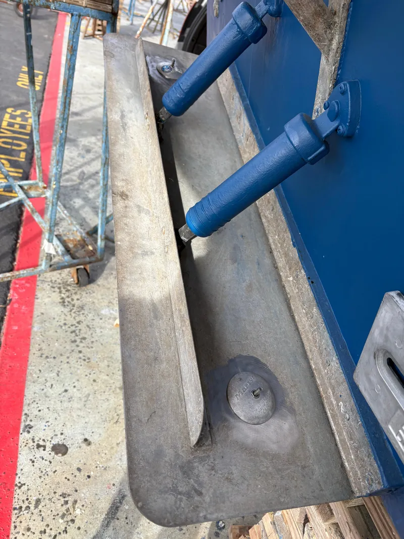 Slide: The Image of Close-up of a 1990 Mediterranean 38 Sport Fisher boat's trim tab and hydraulic system. - 38