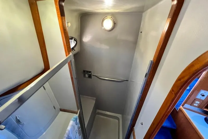 Slide: The Image of Shower area in 1990 Mediterranean 38 Sport Fisher boat with wooden accents and porthole. - 43
