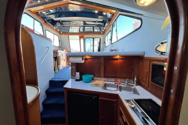 Slide: The Image of Interior of 1990 Mediterranean 38 Sport Fisher yacht with kitchen and seating area. - 45