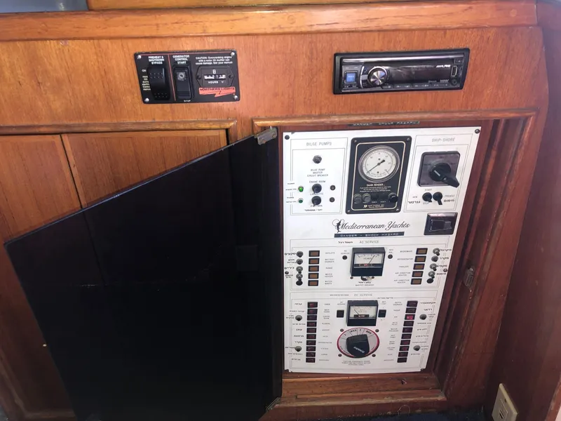 Slide: The Image of Control panel of a 1990 Mediterranean 38 Sport Fisher boat with wooden cabinetry. - 5