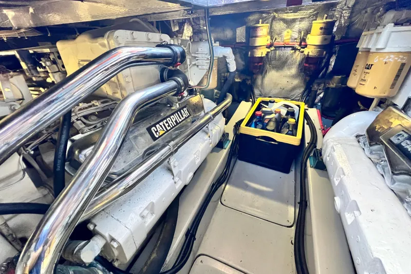 Slide: The Image of Engine room of 1990 Mediterranean 38 Sport Fisher with Caterpillar engines and maintenance supplies. - 53