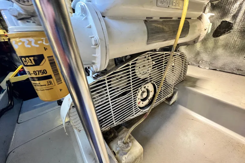Slide: The Image of Engine compartment of a 1990 Mediterranean 38 Sport Fisher boat, featuring a CAT filter. - 55