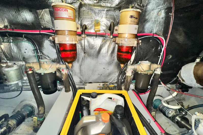 Slide: The Image of Engine room of 1990 Mediterranean 38 Sport Fisher with fuel filters and maintenance supplies. - 58
