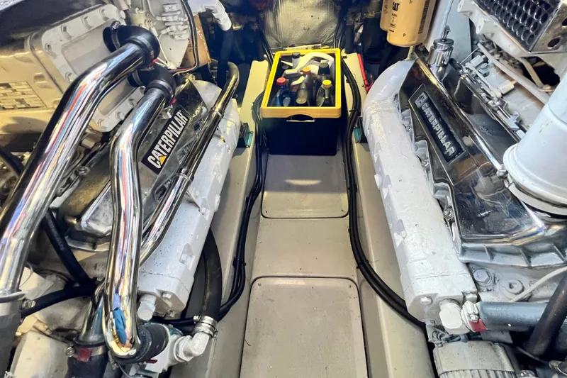 Slide: The Image of Engine room of 1990 Mediterranean 38 Sport Fisher with Caterpillar engines and maintenance tools. - 62